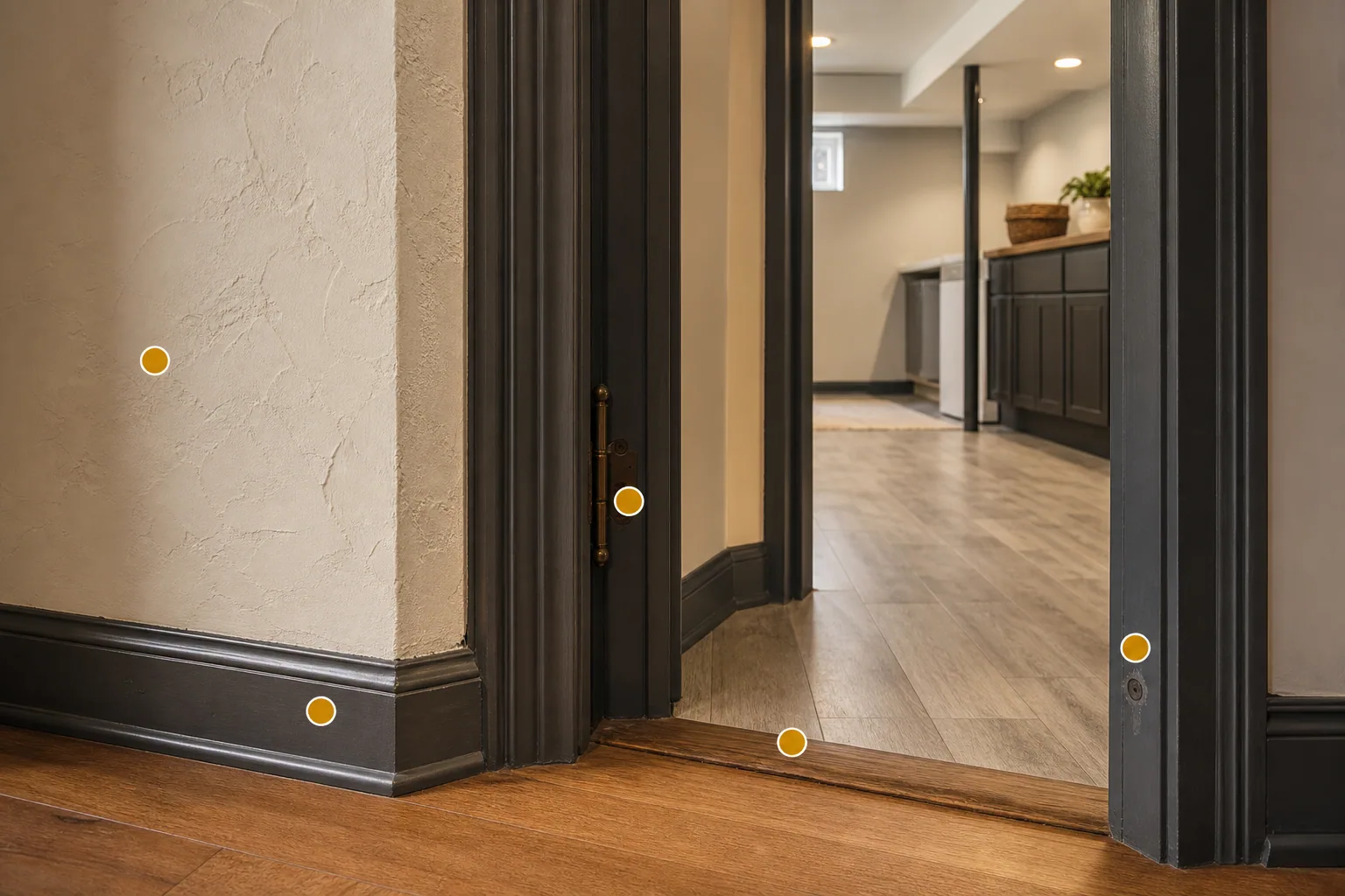 Dakota home interior with older plaster, painted trim, updated flooring transition, basement or utility-area doorway, and amber markers for material review.